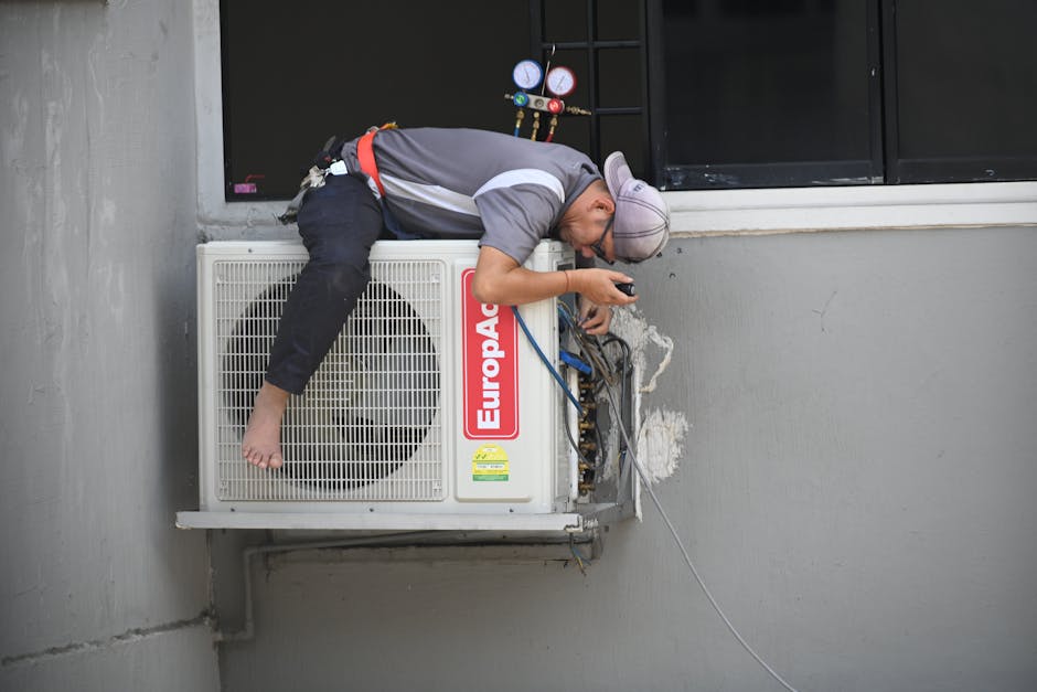 Tucker Hill technician repairing an outdoor AC unit